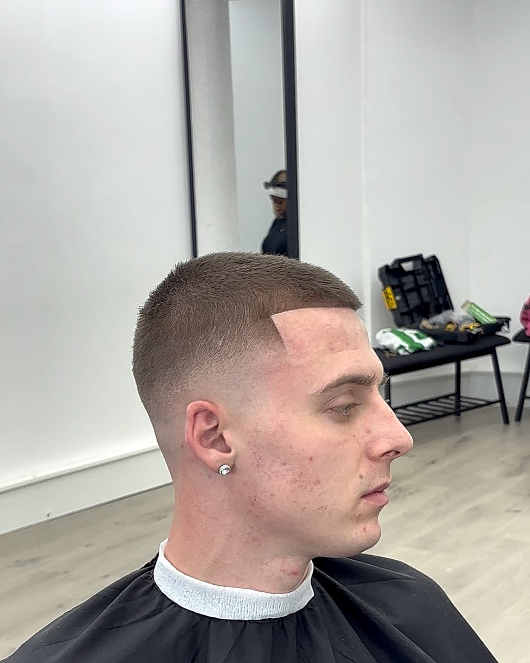 Clean buzz cut with a sharp line-up